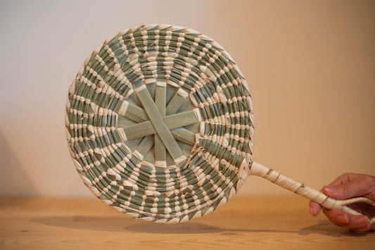 Éventail rond artisanal en feuille de palmier